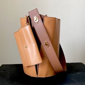 DANSE LENTE mini lorna calf leather bucket shoulder bag in light tan/brown/gold.